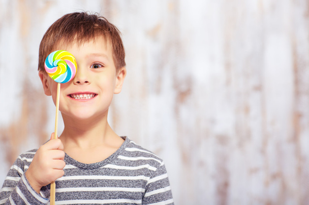 Portrait of little boy with a lollipop - Zdjęcie, obraz