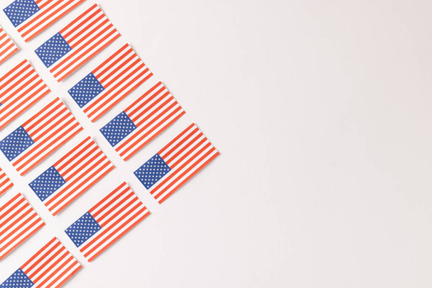 High angle view of rows of flags of united states of america with copy space on white background. American patriotism, independence day and tradition concept. - Foto, afbeelding