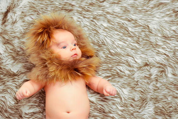 Adorable little baby in a fur hat - Fotoğraf, Görsel