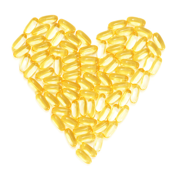 Cod liver fish oil supplements in a healthy heart shape - Fotografie, Obrázek