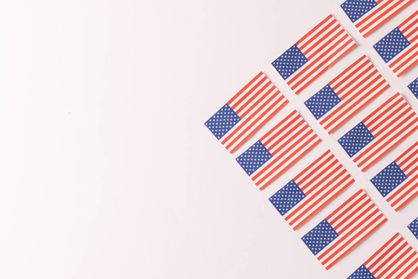 High angle view of rows of flags of united states of america with copy space on white background. American patriotism, independence day and tradition concept. - Fotó, kép