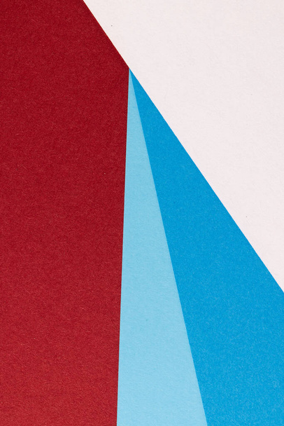 Close up of white and blue paper on red background with copy space. Colour, texture and material. - Foto, Imagem