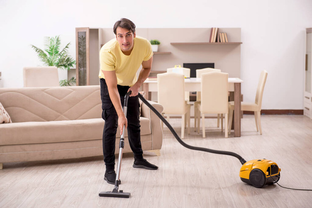 Young man cleaning the house - 写真・画像
