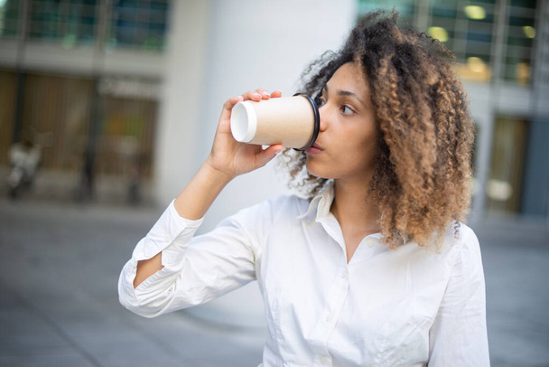 Portrait of african american businesswoman drinking coffee - Фото, изображение