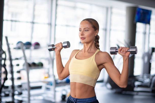 Portrait of a woman working out in a gym - Фото, зображення