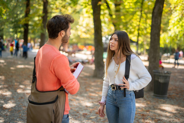 College students talking in a park near their university - Foto, afbeelding