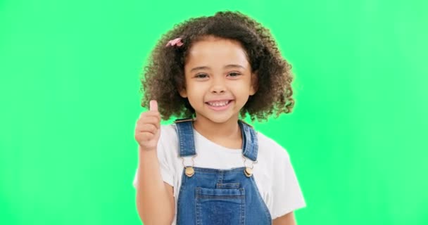 Happy, green screen and face of a child with a thumbs up isolated on a studio background. Winning, success and portrait of a girl kid with an emoji hand gesture for motivation, yes and agreement. - Πλάνα, βίντεο