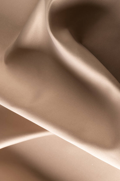 Close up of plain beige satin fabric with folds, copy space. Colour, texture and material. - Foto, immagini