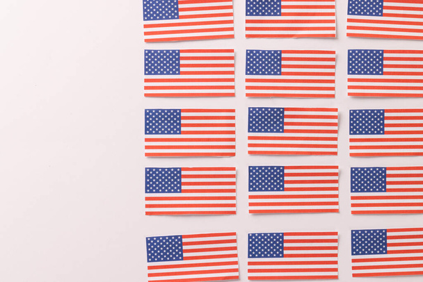High angle view of rows of flags of united states of america with copy space on white background. American patriotism, independence day and tradition concept. - Photo, image
