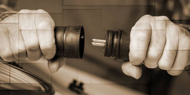 Electrician hands holding electrical plugs, geometric pattern - Фото, изображение