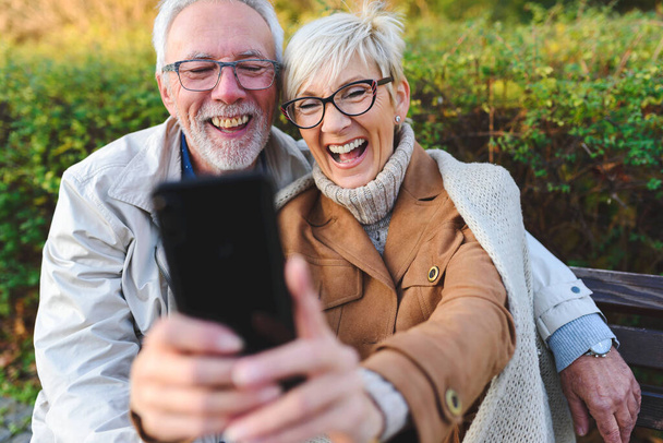 felice coppia di anziani facendo selfie nel parco - Foto, immagini