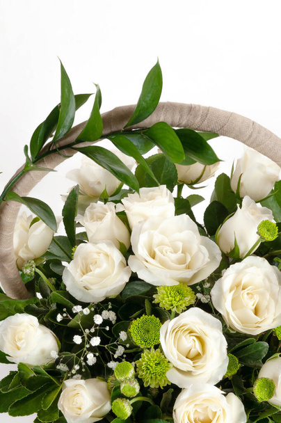 Festive bouquet with white roses in a basket. - Fotó, kép