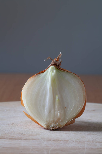 There is an onion cut in half on the table. Copy space. - Foto, imagen