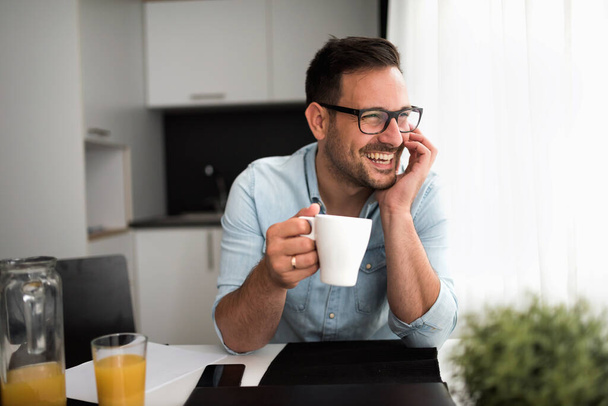 handsome young man with cup of coffee at home - Foto, Imagen