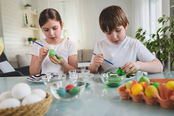 brother and sister preparing to ester, painting eggs - 写真・画像