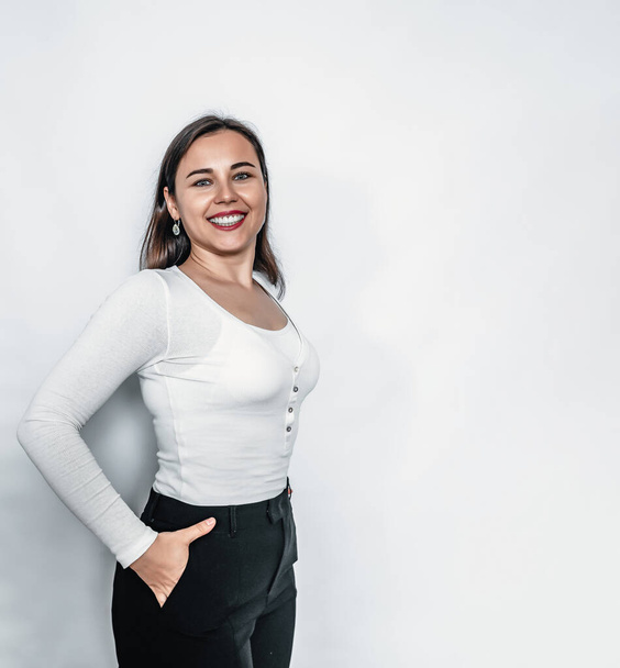 Bright smile on face. Confident business woman in white sweater and black pants - Φωτογραφία, εικόνα