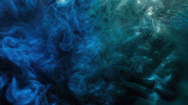 Paint water. Color smoke. Underwater explosion. Blue green glowing glitter fluid splash vapor cloud on dark black abstract art background. - Foto, Imagen