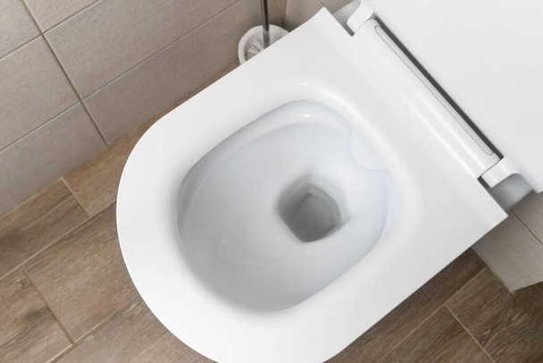 Top view of the new white ceramic toilet in a modern toilet - 写真・画像