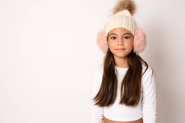 Winter portrait. Happy child portrait. Girl face smile in fur earmuffs. Winter accessories. Child face, horizontal poster, teenager girl isolated portrait, banner with copy space. - Photo, Image