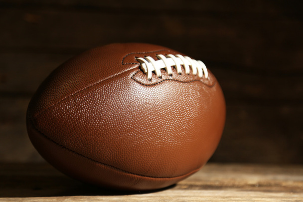 American football on wooden table, close up - Foto, imagen