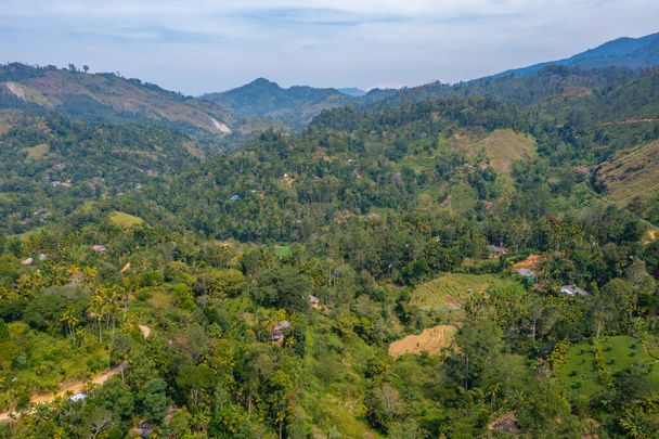 Hilly landscape of Sri Lanka dotted with villages and tea plantations near Ella. - Photo, Image