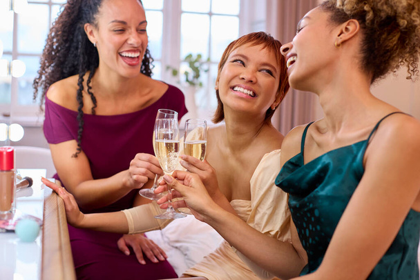Group Of Female Friends At Home Dressed Up And Drinking Champagne Before Night Out - Photo, Image