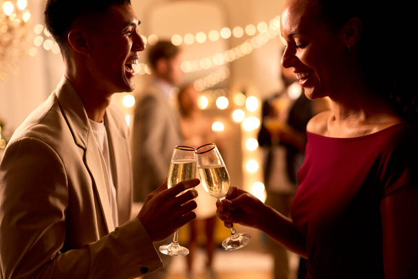 Close Up Of Couple At Party Making Champagne Toast Together - Foto, afbeelding