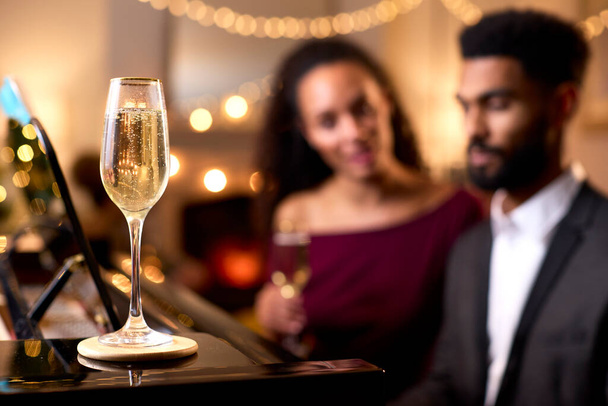 Couple Around Piano Celebrating At Christmas Or New Year Party Together - Photo, image