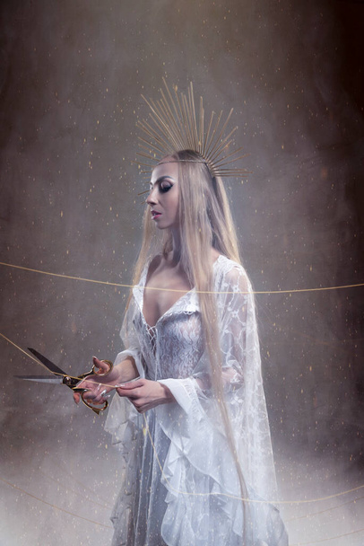 Goddess of fate moira with scissors is preparing to cut the thread of life. Ancient mythology - Fotografie, Obrázek
