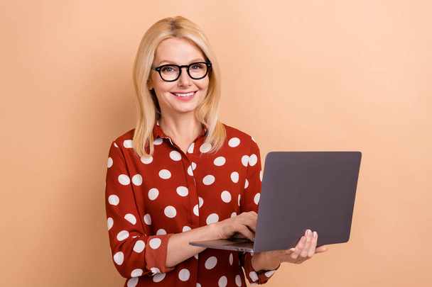 Photo of good mood smart positive woman with bob hairdo wear dotted shirt hold laptop distance work isolated on pastel color background. - Foto, Imagen
