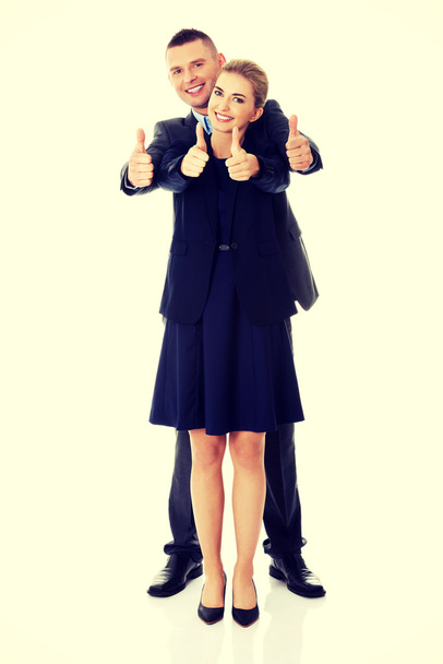 Business couple showing thumbs up sign - 写真・画像