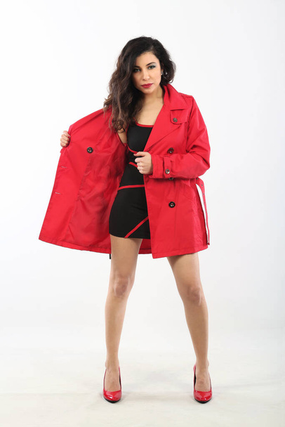 portrait of a beautiful woman wearing fashionable clothing and a red coat - Foto, afbeelding