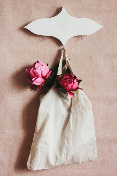 Hanger and shopping bag with flowers. Beautiful handmade wooden hanger. Decorative hanger for home - Fotoğraf, Görsel