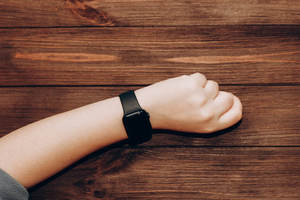 Black technological smart watch in hand. - Foto, imagen