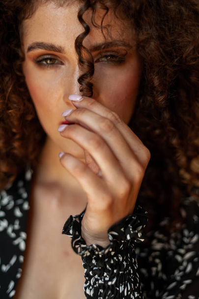 portrait of a young beautiful woman with curly hair - Photo, Image