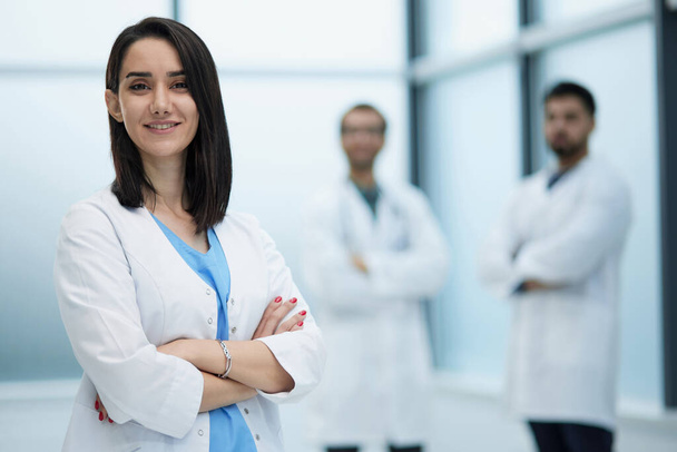 Confident female doctor posing in her office and smiling at camera, health care and prevention concept - Foto, immagini
