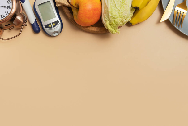 Glucose meter with cutlery and alarm clock on beige background with copy space flat lay, top view. - Photo, Image