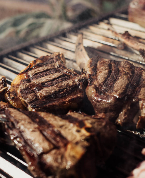 Some excellent pieces of Argentinian beef on a charcoal grill - Photo, Image