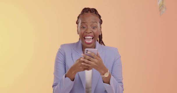 Black woman, phone and dancing in celebration for money, lottery or winning cash prize against a studio background. Happy African American female excited dance for win, discount or sale on smartphone. - Footage, Video