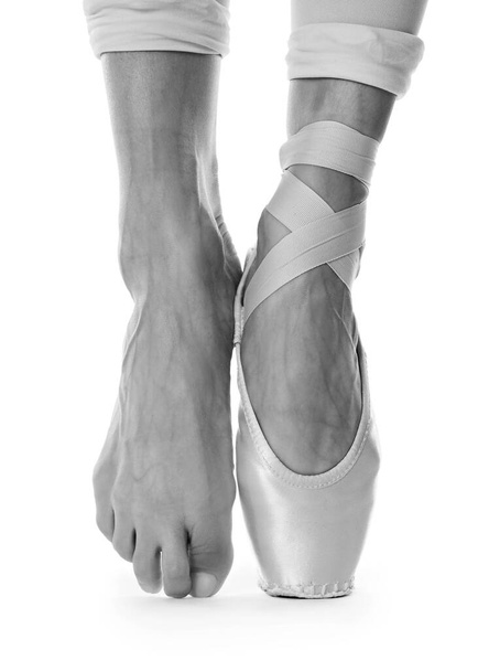 Ballerina in pointe shoe dancing, closeup. Black and white effect - Fotó, kép