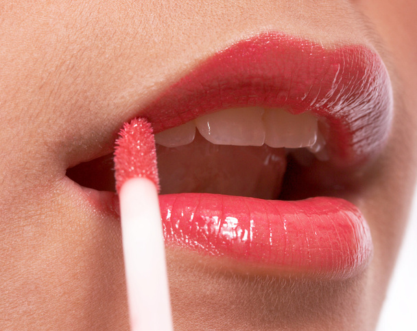 Girl Putting On Lip Gloss - Фото, изображение