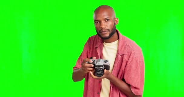 Photographer, camera with a black man on a green screen background in studio for photography. Fashion, magazine and photo shoot with male giving direction while taking a freelance photograph. - Filmati, video