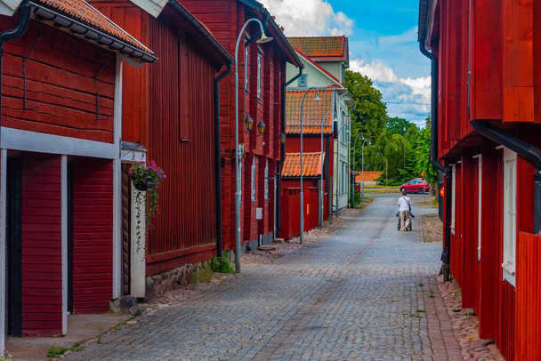 Colorful timber houses alongside a channel in Swedish town Eksjo. - Fotó, kép