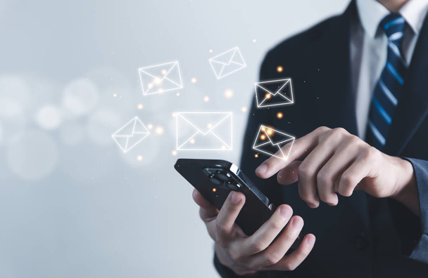 Businessman sending a letter from a smartphone. electronic mail concept is online communication on the Internet network Receiving and sending information or messages in digital technology - Photo, image