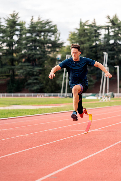 Stock photo of young athlete training with leg prosthesis in running track. - Foto, Bild