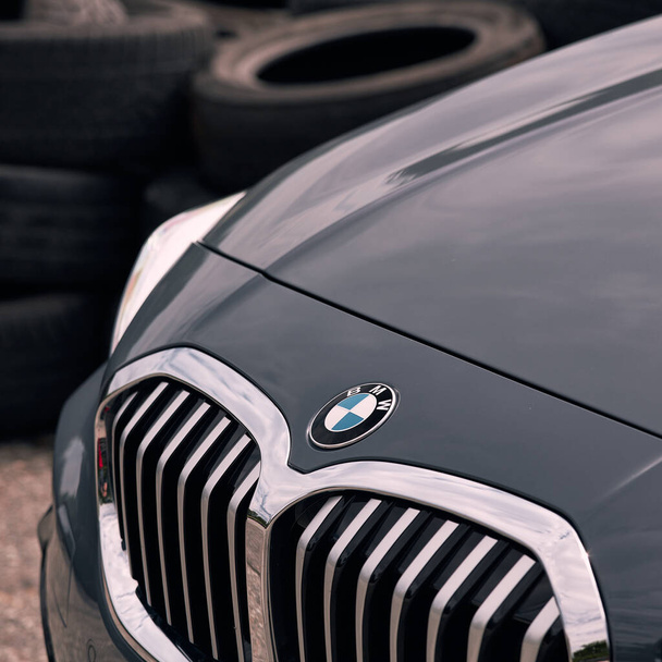 Grill of the BMW 1 series, on the background of used tires.  Model F40, produced from 2019. Katowice, Poland- 19.07.2020 - Фото, изображение