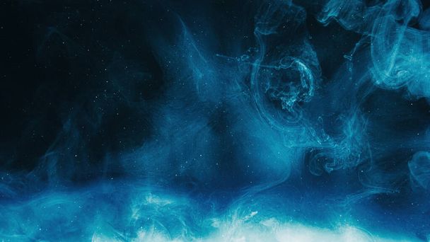Glitter mist. Color cloud. Night sky. Blue shiny sparkling particles smoke floating on dark black abstract art background with copy space. - Zdjęcie, obraz