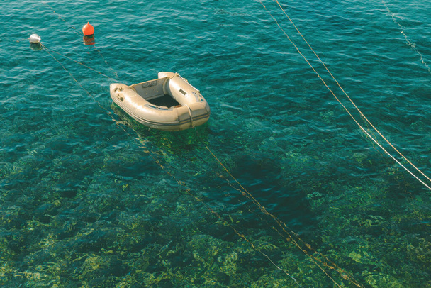 Small inflatable boat moored in Lovran marina at Adriatic sea - Φωτογραφία, εικόνα
