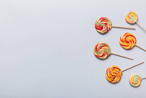 Set of colorful lollipops on colored background. Summer concept. Party Happy Birthday or Minimalist Concept. - 写真・画像