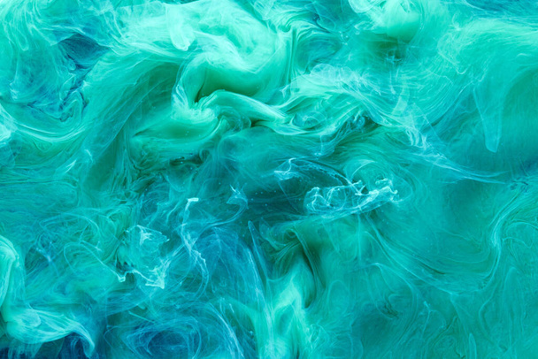 Green blue contrast liquid art background. Paint ink explosion, abstract clouds of smoke mock-up, watercolor underwater - Foto, afbeelding